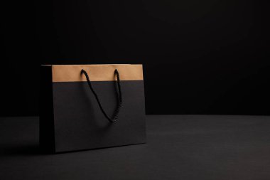 close up view of paper shopping bag on black backdrop clipart