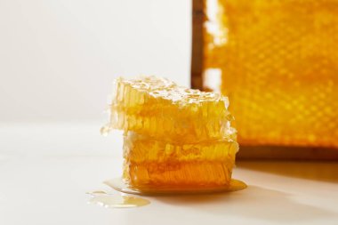 close up view of stack of beeswax on white surface clipart