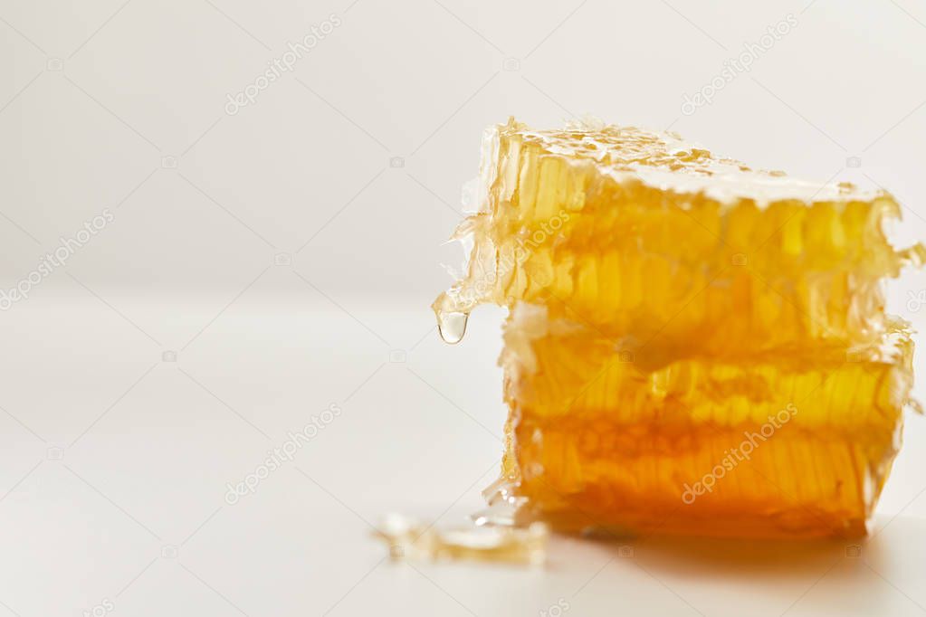 close up view of natural beeswax on white background