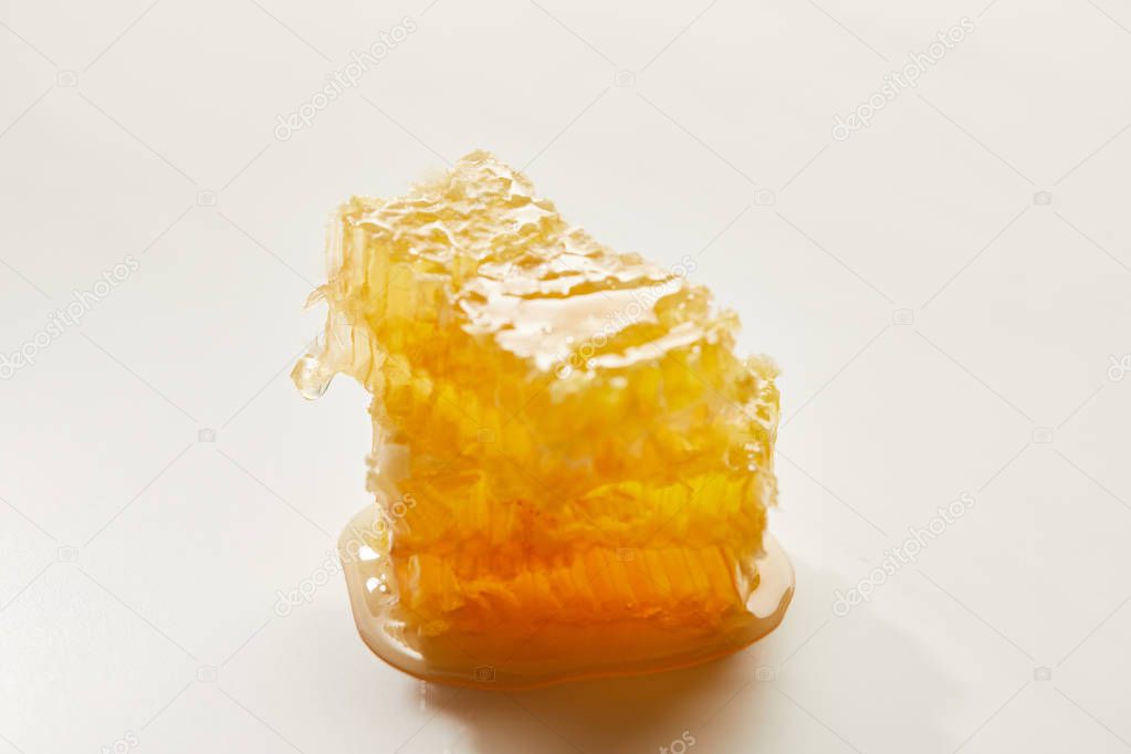close up view of natural beeswax on white background