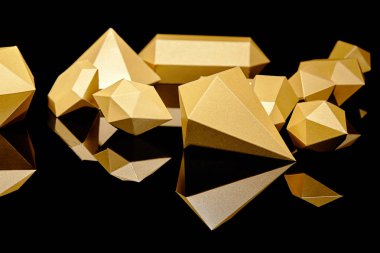 close-up view of shiny faceted golden nuggets reflected on black   clipart