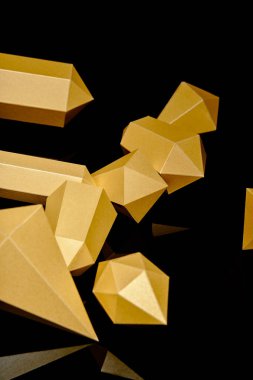 close-up view of shiny faceted pieces of gold reflected on black  clipart