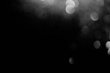 sparking silver bokeh on black background for celebration  clipart