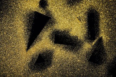 black shapes on golden glittering background clipart