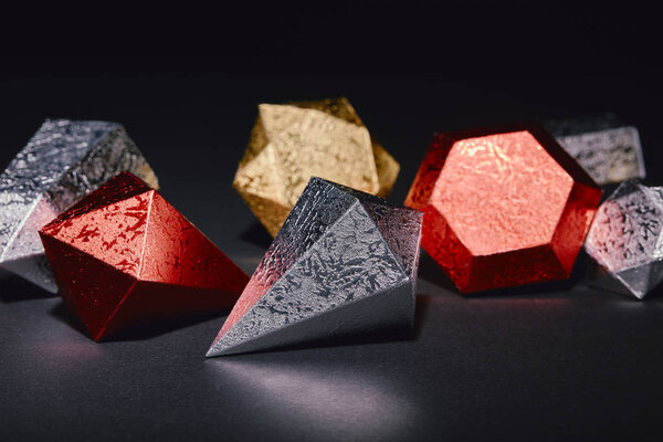 close-up view of shiny golden, red and silver minerals on black