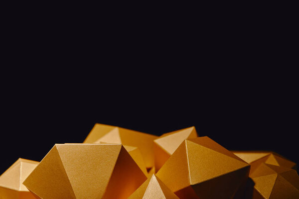 close-up view of faceted golden nuggets isolated on black background