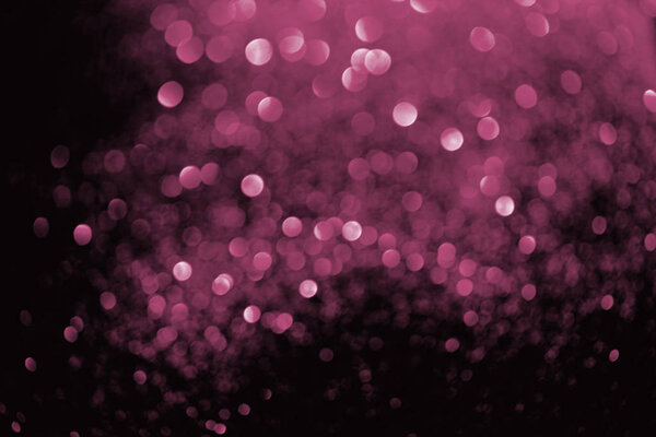 abstract background with blurred glowing pink glitter  