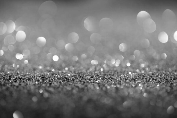 abstract background with glowing silver glitter and bokeh