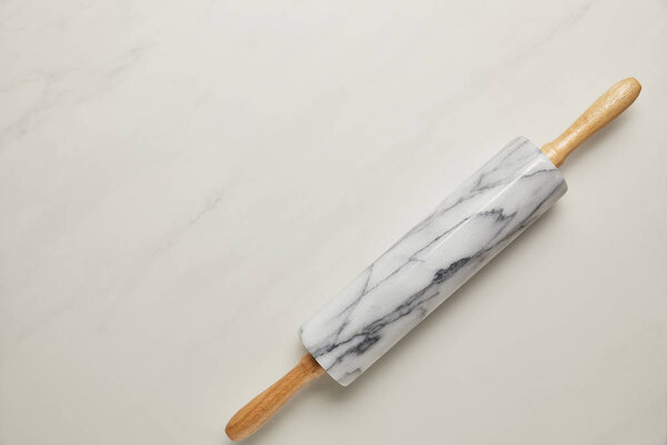 top view of rolling pin on white marble surface