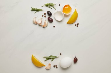 flat lay with raw chicken eggs, rosemary, garlic and black pepper ingredients for italian pasta on white marble surface clipart