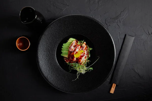 Top View Japanese Ceviche Seafood Avocado Herbs Black Plate — Stok Foto