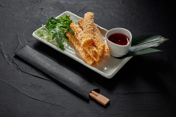 Close-up view of delicious spring rolls with sweet chili sauce and chopsticks — Stock Image Close View Delicious Spring Rolls Sweet Chili Sauce Chopsticks Stock Image