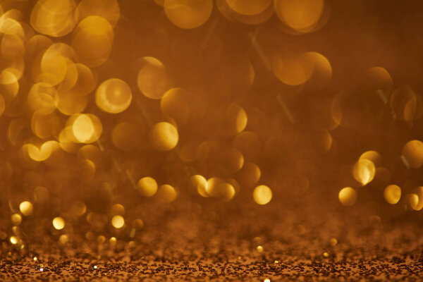 Golden bokeh christmas background with glitter
