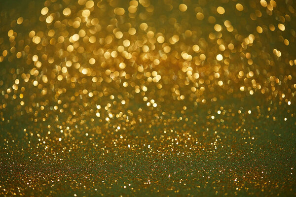 golden and green bokeh christmas background with shiny glitter