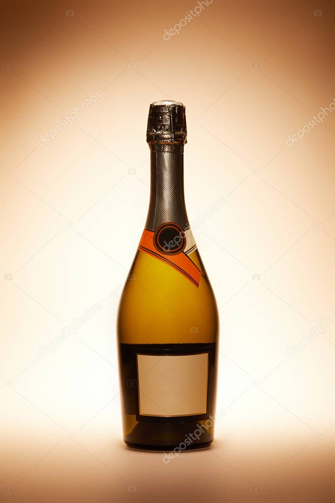 champagne bottle isolated on beige, christmas concept