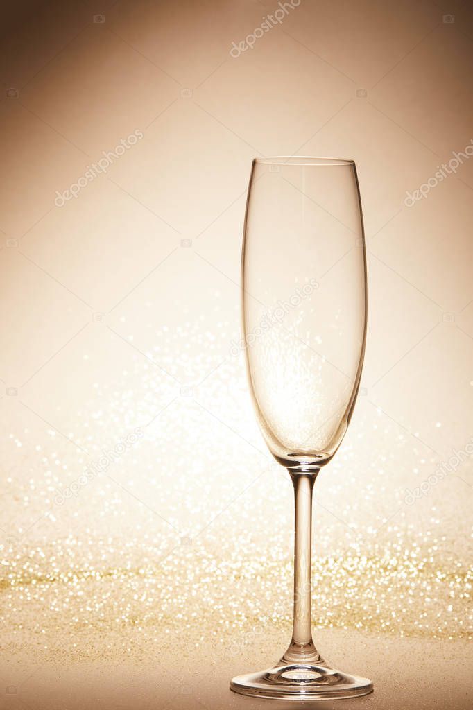 empty wineglass with glitter on tabletop, christmas concept