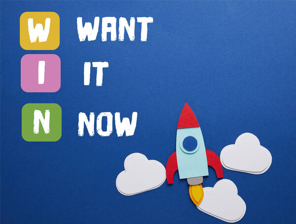 Облака и ракета на синем фоне с "WIN - хочу сейчас" вдохновение
