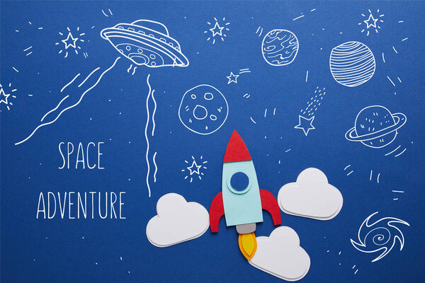 clouds and rocket on blue background with universe icons and "space adventure" inspiration