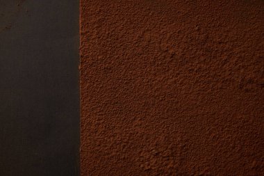 top view of delicious brown cocoa powder on black background  clipart