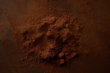 top view of delicious cocoa powder on dark background clipart
