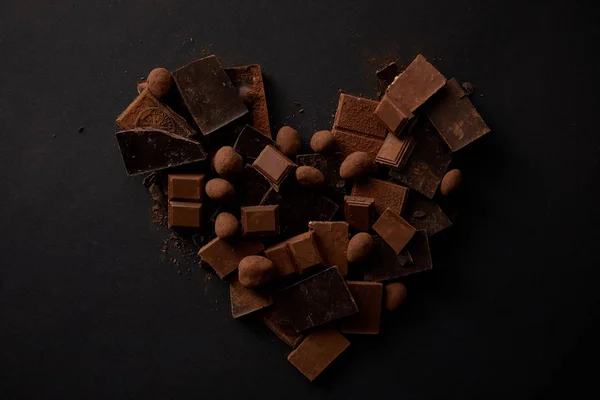 Top View Sweet Gourmet Chocolate Pieces Hazelnuts Arranged Shape Heart — Stock Photo, Image