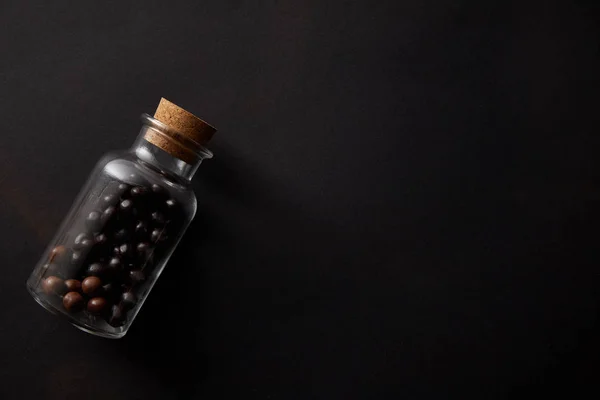 Top View Gourmet Chocolate Balls Glass Jar Black Background — Foto Stok Gratis
