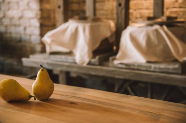 ripe pears on rustic wooden table at cheese manufacture clipart