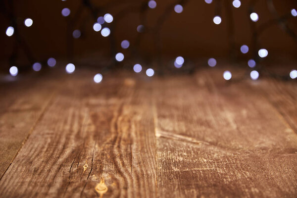 close up view of wooden tabletop and defocused bokeh lights backdrop