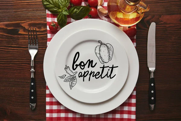 Top View White Plates Bon Appetit Lettering Cutlery Fresh Basil — Stock Photo, Image