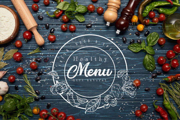 fresh raw vegetables, spices and rolling pin on wooden background with "healthy menu" lettering