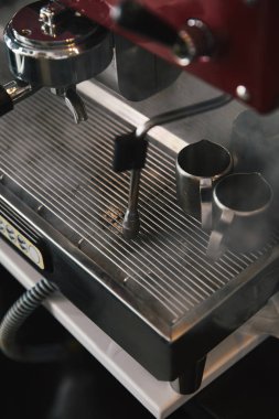 close-up view of professional coffee machine with steam in coffeehouse clipart