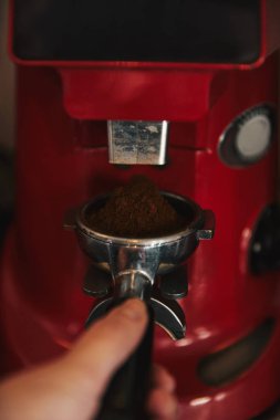 cropped shot of barista preparing espresso in coffee machine  clipart