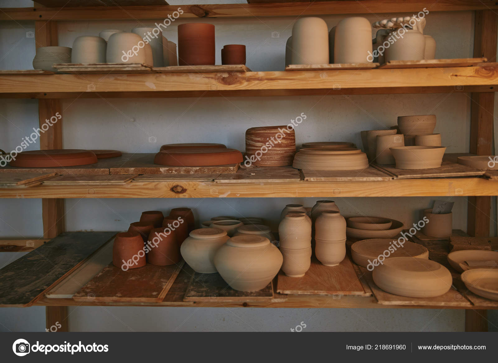 Range of Pottery Molds on a Wooden Shelf in Potters Studio. for