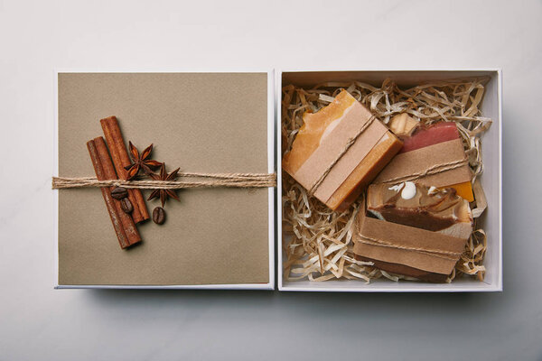 top view of box with soap inside on white marble surface
