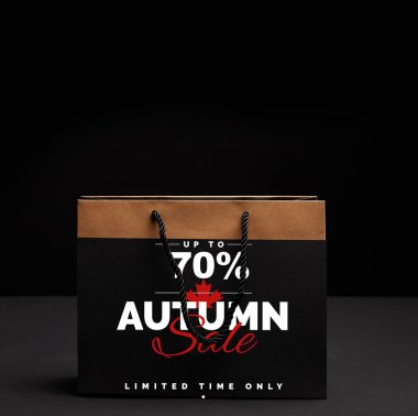paper shopping bag on black backdrop with autumn sale and 70 percents discount clipart