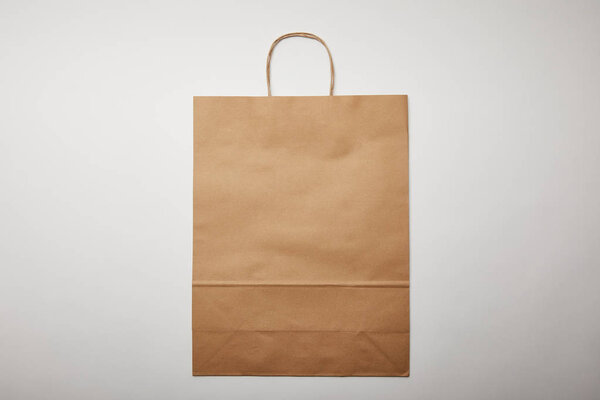 top view of food delivery paper bag on white surface, minimalistic concept 