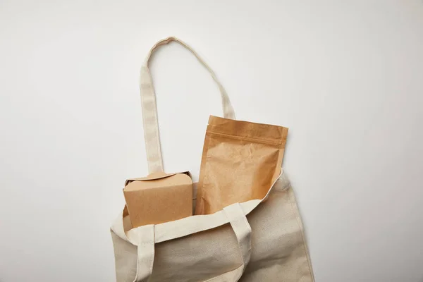 Κάτοψη Του Βαμβακερή Τσάντα Κουτί Από Χαρτόνι Μανέστρα Λευκή Επιφάνεια — Δωρεάν Φωτογραφία