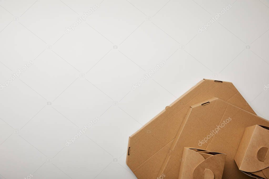 top view of cardboard pizza and noodle boxes on white surface
