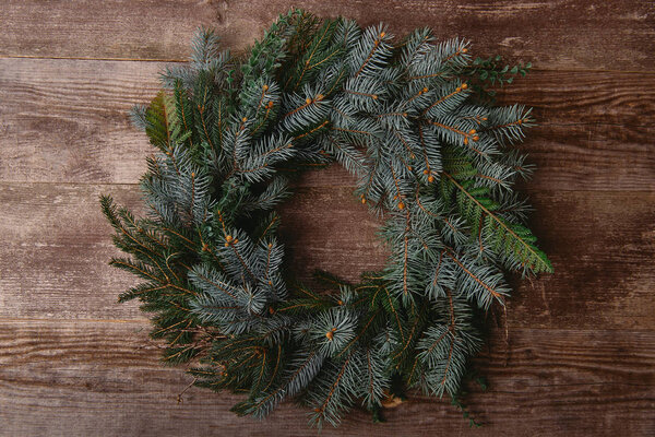 top view of Christmas fir wreath on wooden table