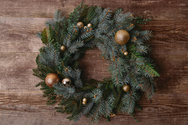 elevated view of Christmas fir wreath with toys on wooden table