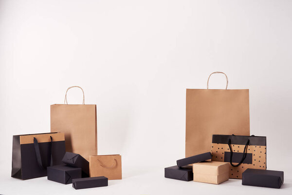 various shopping bags and boxes on white surface, black friday concept
