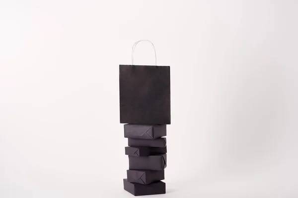 Black Shopping Bag Stacked Boxes White Surface Black Friday Concept — Stock Photo, Image