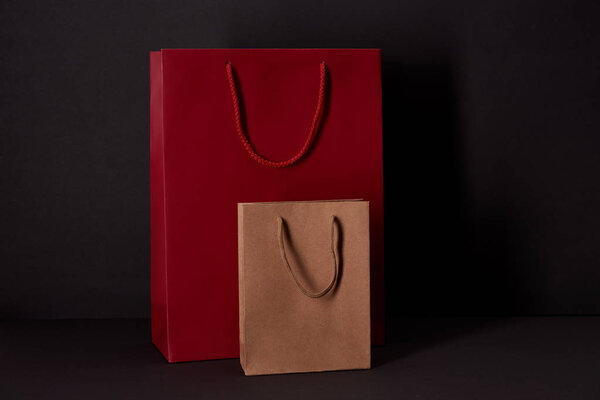 paper bags on black surface, black friday concept