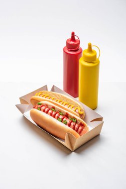 close-up shot of spicy hot dogs with mustard and ketchup on white clipart
