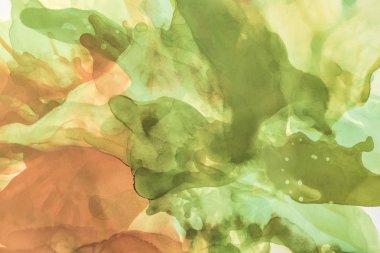 brown and green splashes of alcohol inks as abstract background clipart