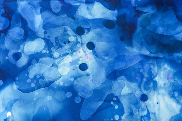 dark blue and blue splashes of alcohol ink as abstract background
