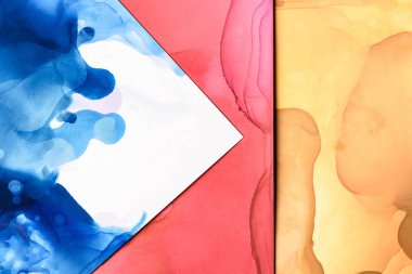 red, blue and yellow splashes of alcohol inks as abstract background clipart