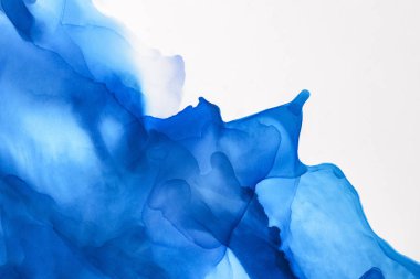 blue splashes of alcohol ink on white as abstract background clipart