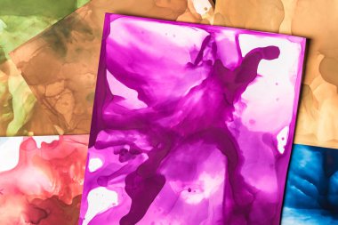 brown, purple and red splashes of alcohol inks as abstract background clipart