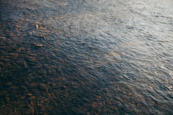 close-up shot of beautiful transparent water over pebbles in mountain river, Carpathians, Ukraine